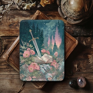 May include: A rectangular case featuring a fantasy illustration. A sword is embedded in an open book, surrounded by pink flowers and a forest scene. The background shows a starry night sky. The case is set on a wooden surface.