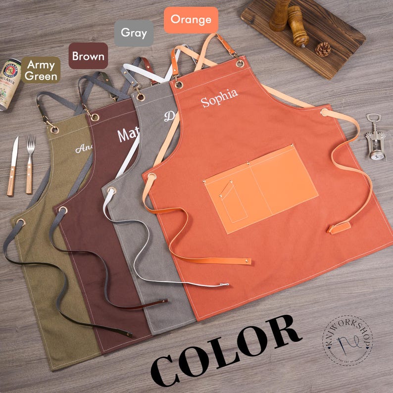 May include: A collection of personalized aprons in various colors, including army green, brown, gray, and orange. Each apron features a pocket and adjustable straps. The aprons are embroidered with names. The word "COLOR" is printed in large letters.
