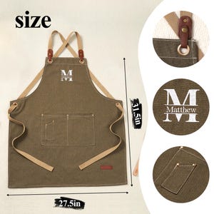 May include: A brown apron with tan straps and pockets. The apron is 70 cm wide and 80 cm long. The apron has the letter "M" and the name "Matthew" printed on it. The apron has a leather strap detail.