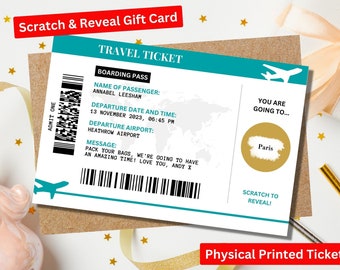 May include: A scratch-off travel ticket gift card with a blue and white design. The card says "TRAVEL TICKET" and "YOU ARE GOING TO..." with a gold circle that says "Paris" underneath. The card has a barcode and a message that says "PACK YOUR BAGS, WE'RE GOING TO HAVE AN AMAZING TIME! LOVE YOU, ANDY X".