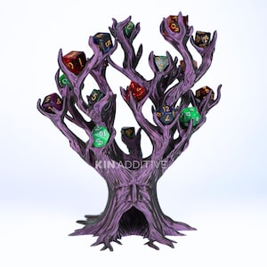 May include: A purple tree-shaped dice holder with a textured bark surface and a carved face at the base. The branches feature multiple notches holding various multi-colored polyhedral dice. The text KINADDITIVE is printed on the trunk.