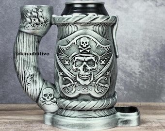 May include: A silver-colored ceramic can holder with a pirate skull design. The holder has a built-in pipe and a small compartment for holding a can.