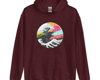 May include: A maroon hoodie with a graphic print of a black monster emerging from a wave. The wave is blue and white with a yellow sun and pink clouds in the background. The monster is breathing fire.
