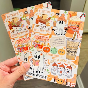 May include: Two fall-themed stickers with orange backgrounds. One sticker features a ghost with a book, and the text "Reading in Peace." The other sticker has a ghost with a coffee cup and the text "Coffee and My Books."