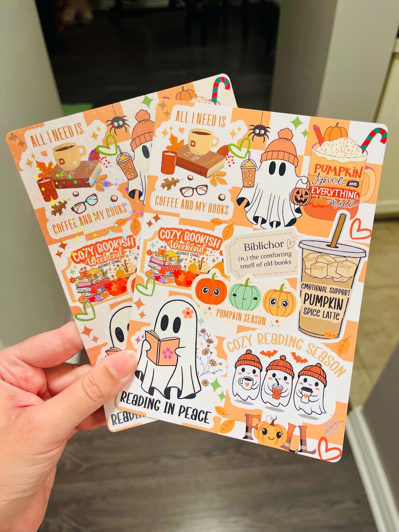May include: Two fall-themed stickers with orange backgrounds. One sticker features a ghost with a book, and the text "Reading in Peace." The other sticker has a ghost with a coffee cup and the text "Coffee and My Books."