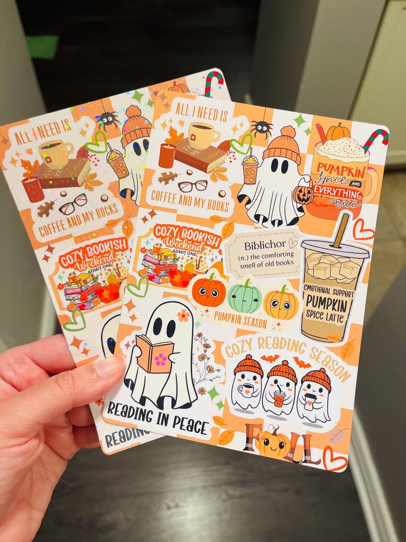 May include: Two fall-themed stickers with ghost illustrations, pumpkins, coffee, and the text "All I Need Is Coffee and My Books." One sticker reads "Cozy Bookish Weekend." The other says "Pumpkin Spice Latte."