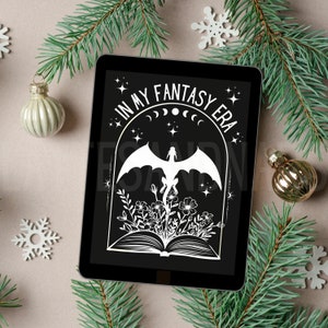 May include: A black tablet with a white design featuring a dragon, flowers, and a book. The text on the tablet reads "In My Fantasy Era".