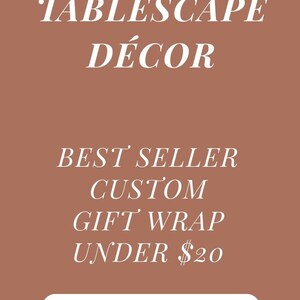 May include: A wrapped gift with a light beige background and a green ribbon tied in a bow. The gift wrap has a forest scene with deer and trees. The image also contains text that reads "Premium Gift Wrap".