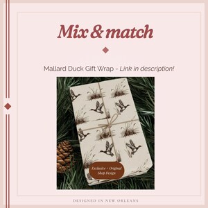 May include: Gift wrap featuring a repeating pattern of mallard ducks and reeds in brown on a cream background. The wrapped package is tied with twine. Text on the image reads "Mix & match" and "Mallard Duck Gift Wrap - Link in description!"