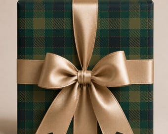 May include: A square gift box wrapped in dark green and olive plaid paper, featuring a wide, smooth, metallic gold satin ribbon tied in a large, centered bow that extends vertically and horizontally across the front of the package.