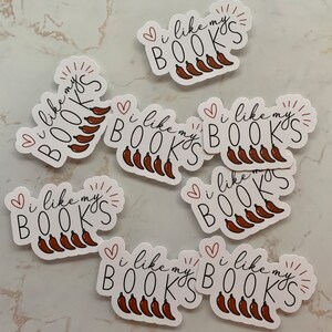 May include: Eight white stickers with the text "I like my BOOKS" and a red heart and a red sunburst. Each sticker has a row of five red chili peppers.