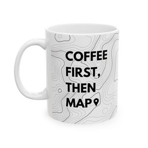 May include: White ceramic coffee mug with a topographic map design and the text "COFFEE FIRST, THEN MAP" in black.