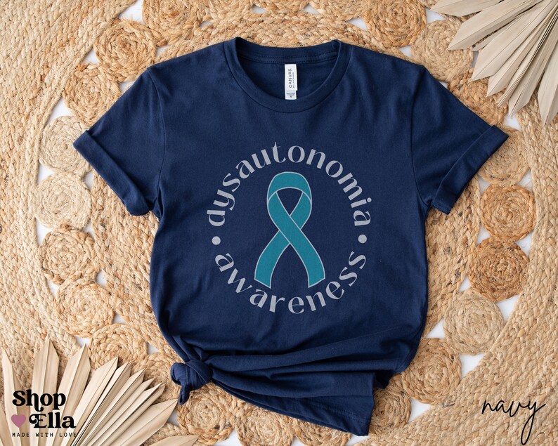 May include: Navy blue t-shirt featuring a teal ribbon and the text "dysautonomia awareness" in a circle around the ribbon.