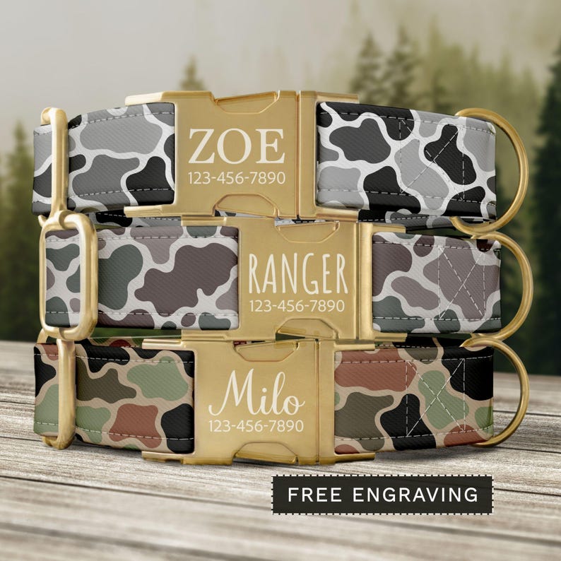 May include: Three personalized dog collars with camouflage patterns in gray, brown, and green. Each collar features a gold-colored buckle with a name and phone number. The collars are labeled "Zoe", "Ranger", and "Milo". The text "FREE ENGRAVING" is also visible.