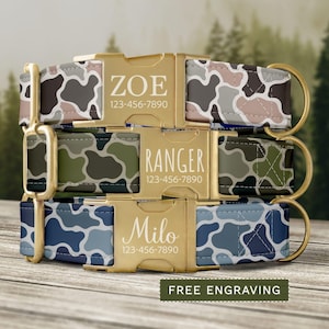 May include: Three personalized dog collars with camouflage patterns in shades of gray, pink, green, and blue. Each collar features a gold-colored buckle engraved with a name and phone number. The text "FREE ENGRAVING" is at the bottom.