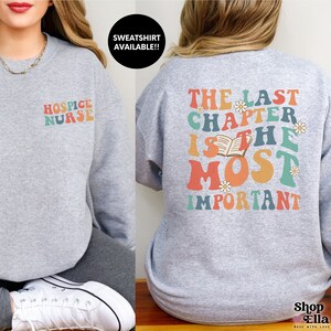 Custom hospice nurse sweatshirt on sports grey gildan crewneck "the last chapter is the most important" on back and "hospice nurse" on front. retro wavy rainbow style.