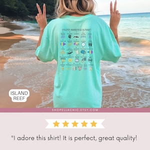 epilepsy awareness shirt with awareness alphabet A-Z. Purple ribbon month t-shirt on ivory comfort colors tee oversized on color island reef