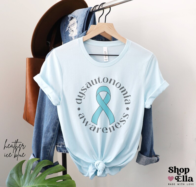 May include: Light blue t-shirt with a teal ribbon and the text "dysautonomia awareness" in a circle.