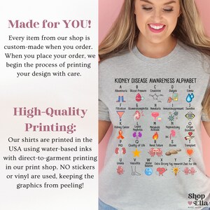 May include: A gray t-shirt with a graphic print of an alphabet representing terms related to kidney disease awareness. The text "KIDNEY DISEASE AWARENESS ALPHABET" is printed at the top of the graphic. Each letter of the alphabet is paired with an illustration and a term related to kidney disease. The shirt also has the text "Made for YOU!" and "High-Quality Printing:" printed on it.