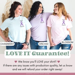 May include: Three women wearing different colored t-shirts with a purple ribbon and the text "Epilepsy Awareness". The t-shirts are in the colors Chambray, Orchid, and Blossom.