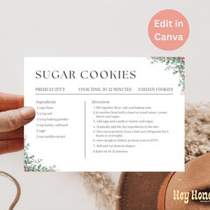 Puede incluir: Una tarjeta de receta imprimible con un diseño de hojas verdes y el título "Sugar Cookies". La receta incluye ingredientes como harina, mantequilla, huevos y extracto de vainilla. También incluye instrucciones para hacer las galletas, incluyendo precalentar el horno a 275 grados Fahrenheit y hornear durante 10-12 minutos.