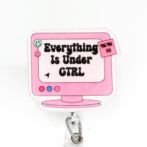 May include: Pink computer monitor with a sticky note that says "Everything is Under CTRL". The monitor has a pink, blue, and red circle on the bottom. The monitor is attached to a retractable badge reel.