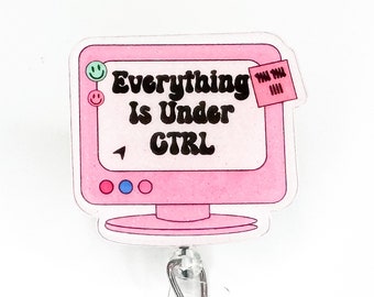 May include: Pink computer monitor with a sticky note that says "Everything is Under CTRL". The monitor has a pink, blue, and red circle on the bottom. The monitor is attached to a retractable badge reel.