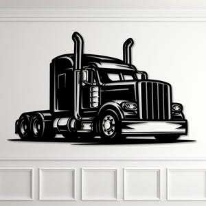 May include: Black and white illustration of a semi-truck. The truck features a detailed design with visible wheels, a large front grill, and exhaust pipes. The artwork is mounted on a white wall above a wooden floor.