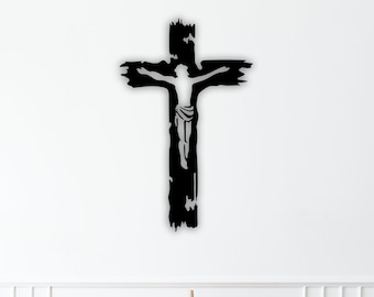 May include: Black metal wall art featuring a distressed cross with a silhouette of Jesus Christ. The cross is mounted on a white wall above a wooden dresser with two drawers.