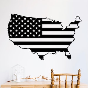 May include: Black and white metal wall art depicting the outline of the United States with the American flag design.