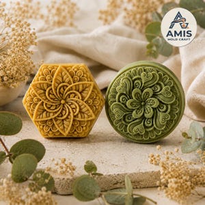 Peut inclure: Deux moules à savon décoratifs, l'un hexagonal et l'autre circulaire, présentant des motifs floraux en relief complexes. Le moule hexagonal est jaune moutarde, tandis que le circulaire est vert sauge. Tous deux arborent des détails sculptés.