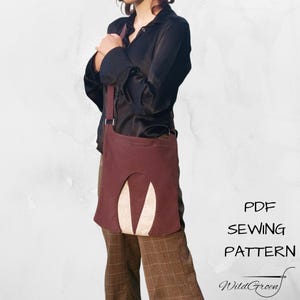 May include: A burgundy shoulder bag with a unique cut-out design, featuring a beige accent. The bag has a long strap and is worn over the shoulder. The text "PDF SEWING PATTERN" and "WildGreen" are visible.