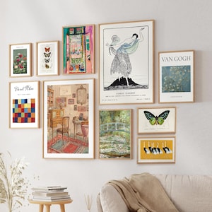 May include: A collection of framed art prints displayed on a wall. The prints feature various styles, including botanical illustrations, abstract designs, and classic art reproductions. The frames are a natural wood color, and the overall aesthetic is vintage and artistic.