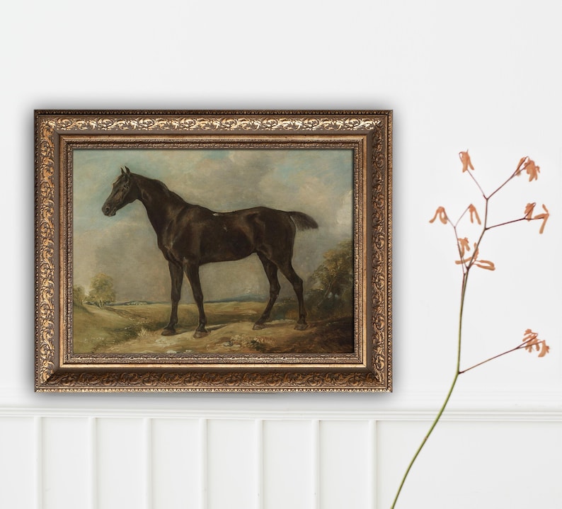 May include: An antique framed painting of a dark brown horse standing in a field. The horse is the focal point, set against a backdrop of a cloudy sky and a landscape with trees. The frame is ornate with a gold finish.