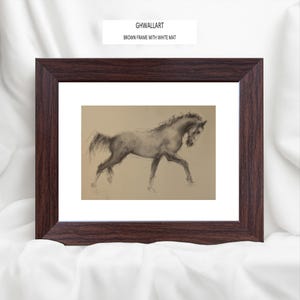 May include: A framed artwork featuring a charcoal sketch of a horse in motion. The drawing is set against a tan background with a white mat, encased in a dark brown wooden frame. The text "GHWALLART BROWN FRAME WITH WHITE MAT" is visible.
