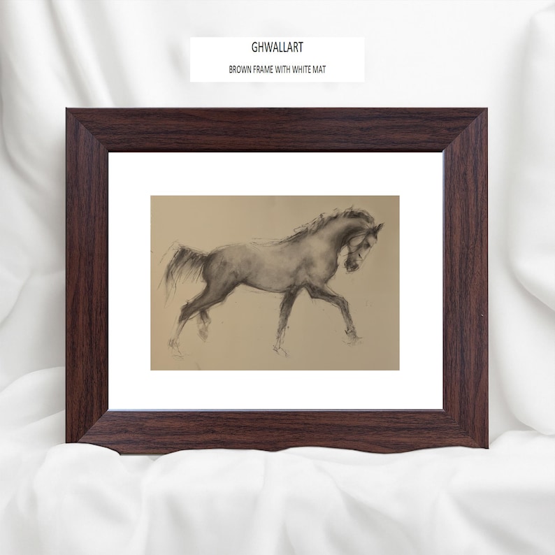 May include: A framed artwork featuring a charcoal sketch of a horse in motion. The drawing is set against a tan background with a white mat, encased in a dark brown wooden frame. The text "GHWALLART BROWN FRAME WITH WHITE MAT" is visible.