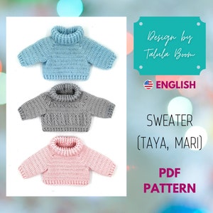 Puede incluir: Tres suéteres de crochet en azul, gris y rosa. Los suéteres tienen un estilo de cuello alto y están diseñados para muñecas. La imagen incluye el texto "Design by Talula Boom", "ENGLISH", "SWEATER (TAYA, MARI)" y "PDF PATTERN".