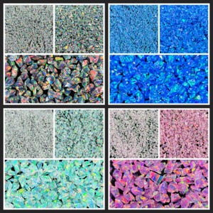 May include: A collection of crushed opal gemstones in a variety of colours, including blue, green, purple, and grey. The gemstones have an iridescent sheen and a mix of rough and polished textures. The image is well-lit, highlighting the colour variations.