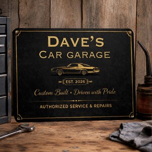 May include: A rectangular black sign with gold lettering and a gold car graphic. The text reads: DAVE'S CAR GARAGE, EST. 2026, Custom Built • Driven with Pride, and AUTHORIZED SERVICE & REPAIRS. The sign features a decorative gold border.
