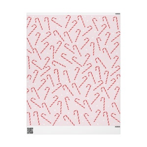 May include: A pink background with a repeating pattern of red and white candy canes. The candy canes are scattered randomly across the background.