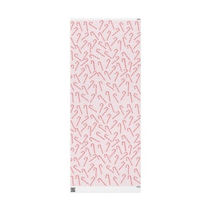 May include: Pink and white wrapping paper with a repeating pattern of red and white candy canes.