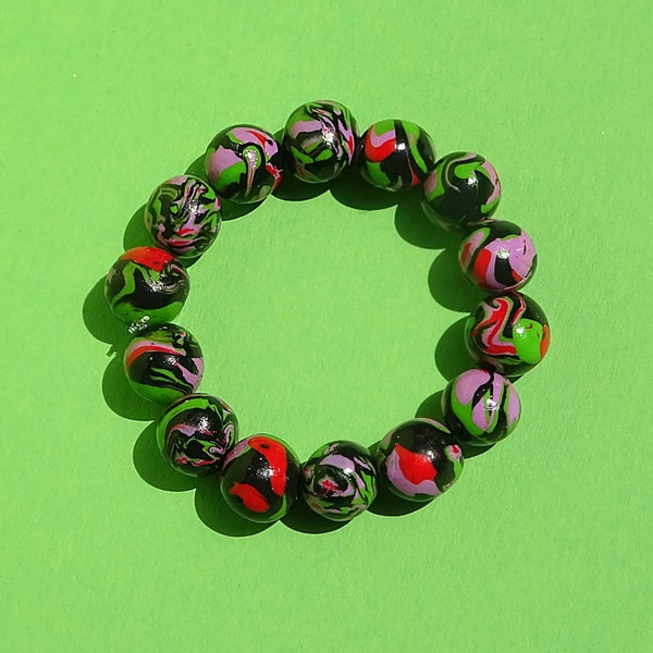 Unique handmade green/purple/red/black beaded polymer clay bracelet, with transparent elastic string by Lina Flowrez