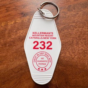 May include: White plastic key chain with a red circle that says "Drop in any mail box. We guarantee postage." and the text "Kellerman's Mountain Resort Catskills, New York 232".