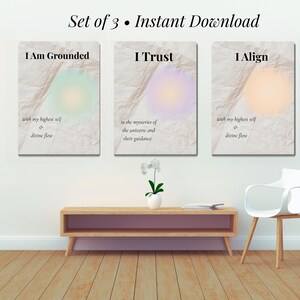 May include: A set of three art prints with the phrases "I Am Grounded", "I Trust", and "I Align". Each print has a soft, colorful aura design and text. The words "Set of 3 • Instant Download" are at the top.