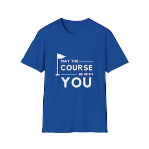 May include: Royal blue t-shirt with a white graphic. The graphic includes a golf flag and the text "MAY THE COURSE BE WITH YOU". The shirt is a crew neck and appears to be made of cotton.