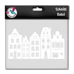 Peut inclure: Fichier de découpe SVG représentant une rangée de cinq maisons blanches avec des fenêtres et des portes. Le motif est sur un fond gris avec un logo de colibri en haut à gauche et le texte "Schnitt Datei" en haut à droite.