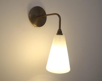 Aplique de pared de alabastro hecho a mano, detalles en latón, iluminación minimalista.