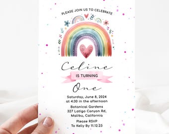May include: A rainbow-themed first birthday party invitation featuring a watercolour rainbow, pink flowers, and a pink heart. The invitation reads "Please join us to celebrate Celine is turning One" and includes the date, time, location, and RSVP details.