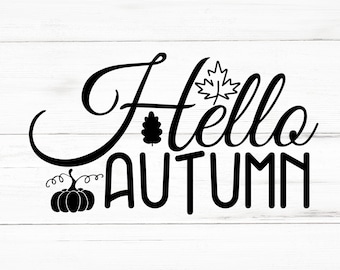 May include: Black text on a white wooden background reads "Hello Autumn." The word "Hello" is in a cursive font, and "Autumn" is in a bold, block font. A pumpkin, a maple leaf, and an oak leaf are included.