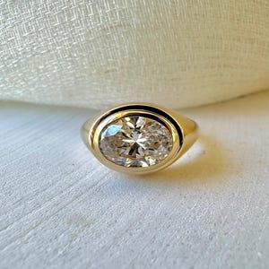 18K Oval Lab Diamond Ring, in a Signet Ring style featuring a bezel set 2ct Oval Lab Diamond | Ella Creations Jewelry